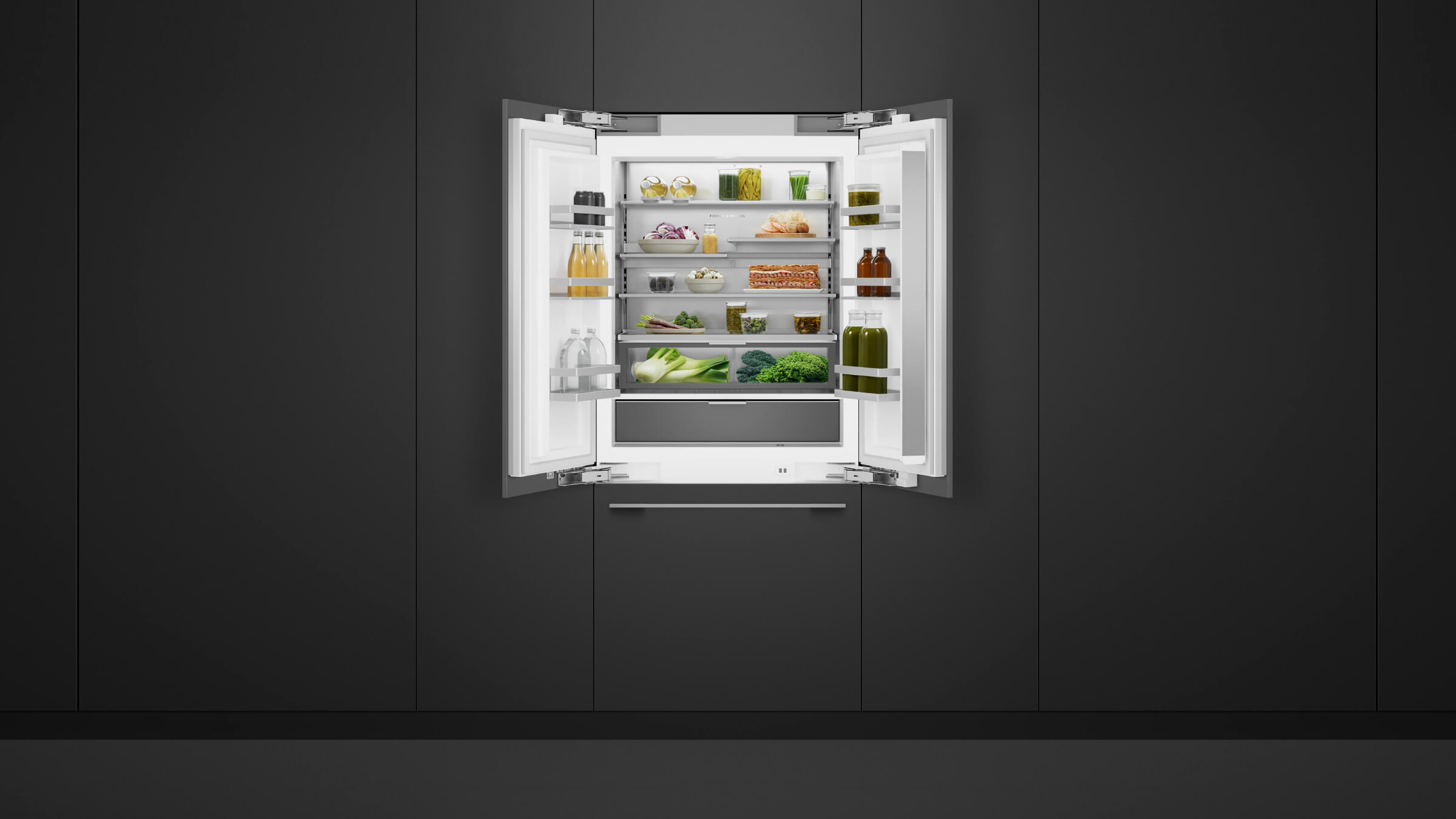 A trio of integrated refrigeration columns installed flush in a dark wood kitchen environment